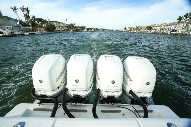  Yacht Photos Pics 2013 SeaVee 390B boat with four powerful outboard engines cruising on a scenic waterway.