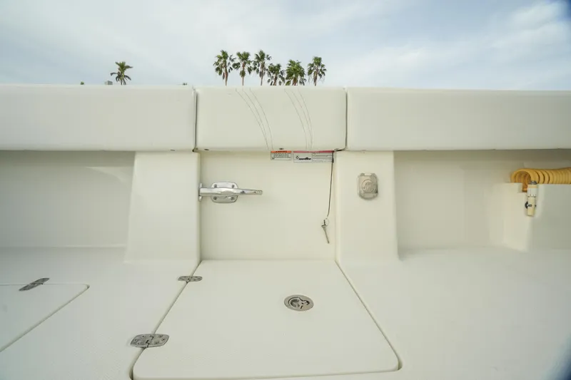  Yacht Photos Pics 2013 SeaVee 390B boat deck with storage compartments and palm trees in background.