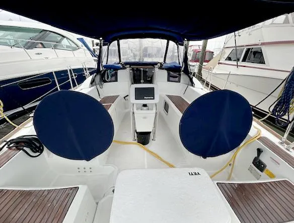 Escape Yacht Photos Pics Cockpit of 2018 Jeanneau Sun Odyssey 389 sailboat with blue covers and modern navigation equipment.