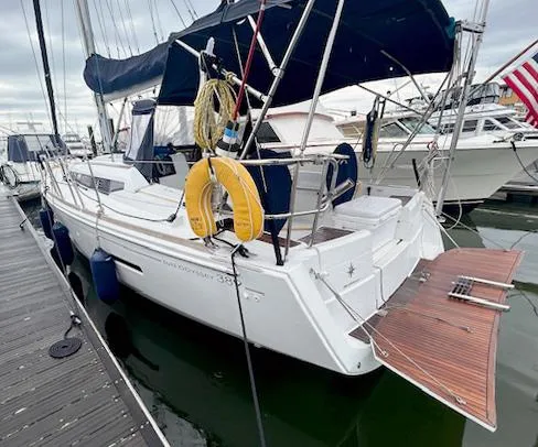 Escape Yacht Photos Pics 2018 Jeanneau Sun Odyssey 389 sailboat docked, featuring a spacious deck and safety equipment.