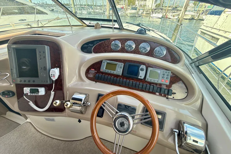 Off The Air Yacht Photos Pics Helm of 2004 Sea Ray 380 Sundancer with navigation instruments and steering wheel.