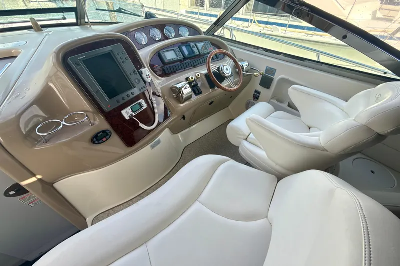 Off The Air Yacht Photos Pics 2004 Sea Ray 380 Sundancer helm with modern controls and plush seating.