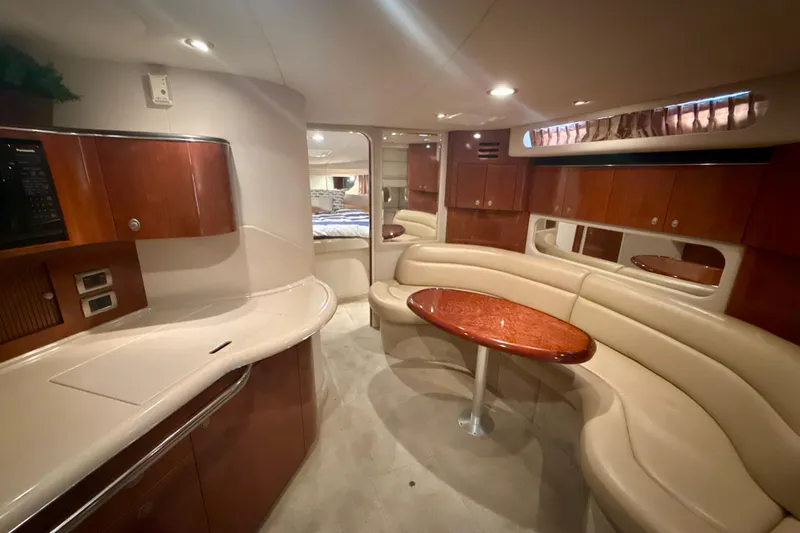 Off The Air Yacht Photos Pics Luxurious interior of 2004 Sea Ray 380 Sundancer yacht with elegant seating and wood finishes.