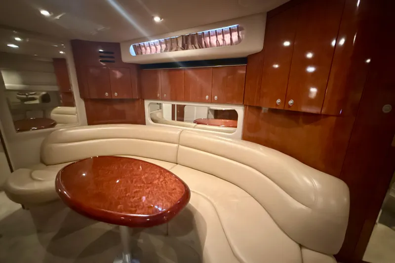 Off The Air Yacht Photos Pics Luxurious interior of 2004 Sea Ray 380 Sundancer with leather seating and polished wood table.