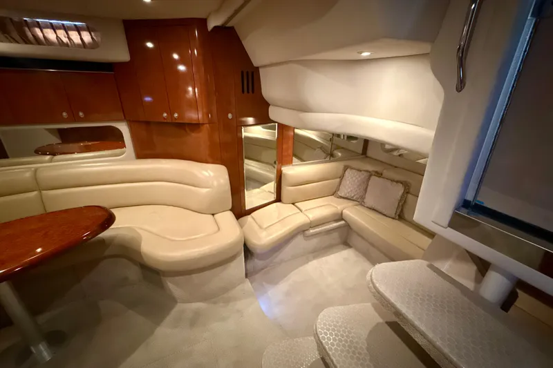 Off The Air Yacht Photos Pics Luxurious interior of 2004 Sea Ray 380 Sundancer yacht with plush seating and wooden cabinetry.