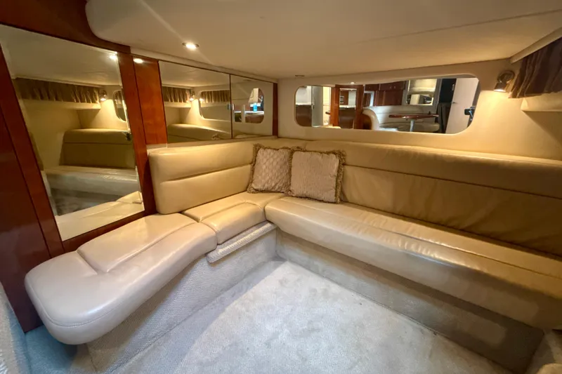 Off The Air Yacht Photos Pics Luxurious interior of 2004 Sea Ray 380 Sundancer with beige leather seating and mirrors.