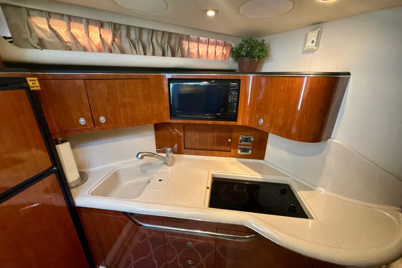 Off The Air Yacht Photos Pics Luxurious 2004 Sea Ray 380 Sundancer yacht kitchen with wood cabinets and modern appliances.