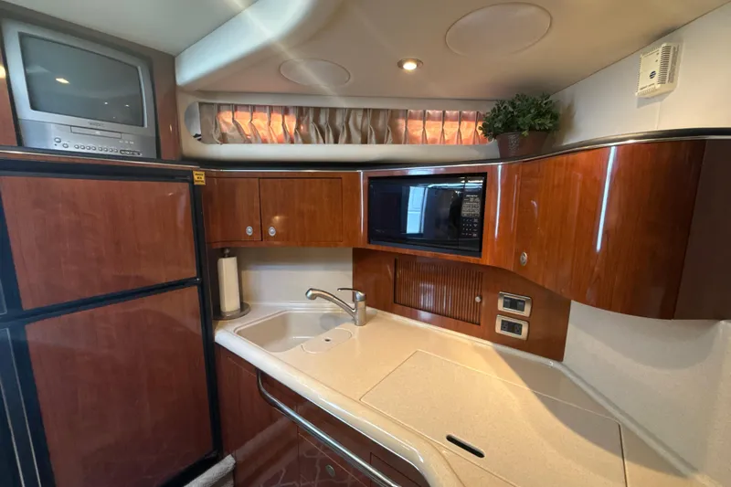 Off The Air Yacht Photos Pics Luxurious 2004 Sea Ray 380 Sundancer yacht kitchen with wood cabinets and modern appliances.