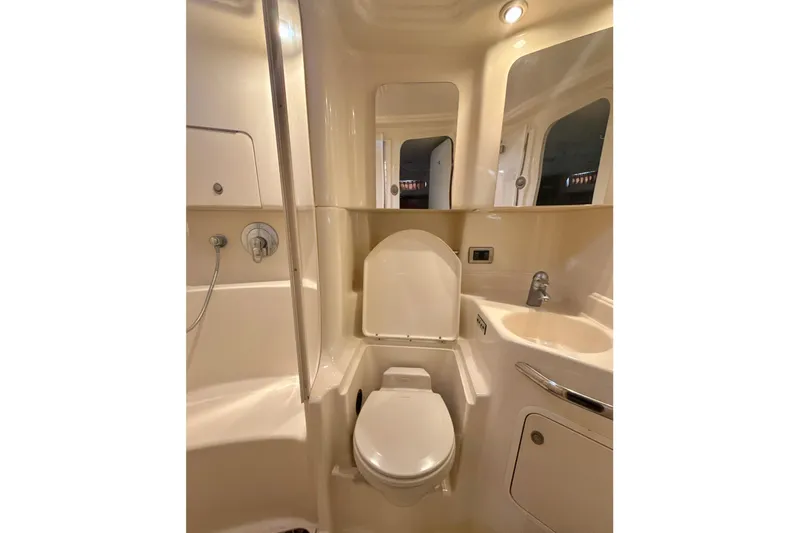 Off The Air Yacht Photos Pics 2004 Sea Ray 380 Sundancer bathroom with shower, toilet, and sink.
