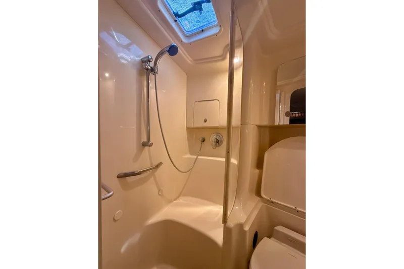 Off The Air Yacht Photos Pics 2004 Sea Ray 380 Sundancer bathroom with shower, skylight, and modern fixtures.