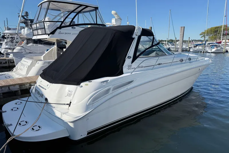 Off The Air Yacht Photos Pics 2004 Sea Ray 380 Sundancer yacht docked at marina, featuring sleek design and black canopy.