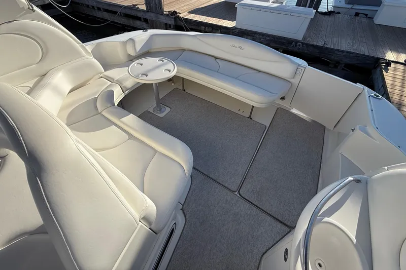 Off The Air Yacht Photos Pics 2004 Sea Ray 380 Sundancer boat interior with white seating and small table.
