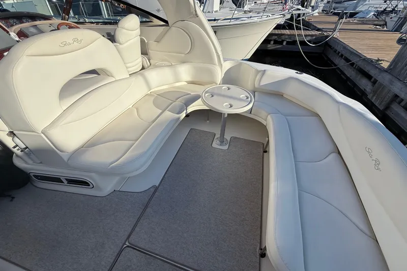 Off The Air Yacht Photos Pics 2004 Sea Ray 380 Sundancer interior with white leather seating and small table.