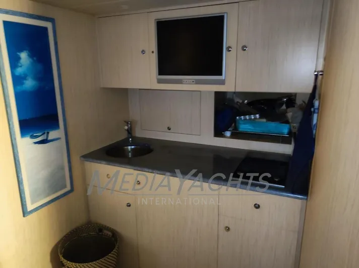  Yacht Photos Pics 2005 Uniesse 48 Open yacht interior with kitchenette, sink, and wall art.