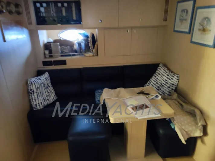  Yacht Photos Pics Interior of 2005 Uniesse 48 Open yacht with cozy seating and table.