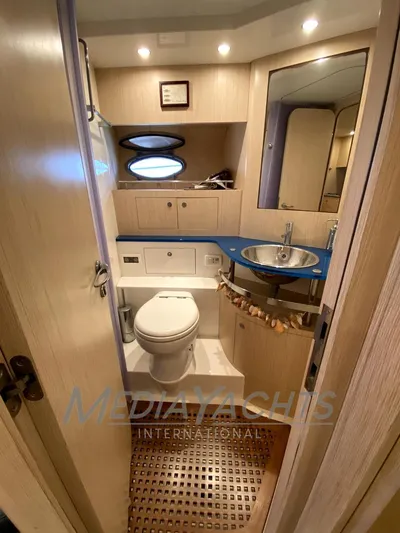  Yacht Photos Pics 2005 Uniesse 48 Open yacht bathroom with modern fixtures and wooden cabinetry.