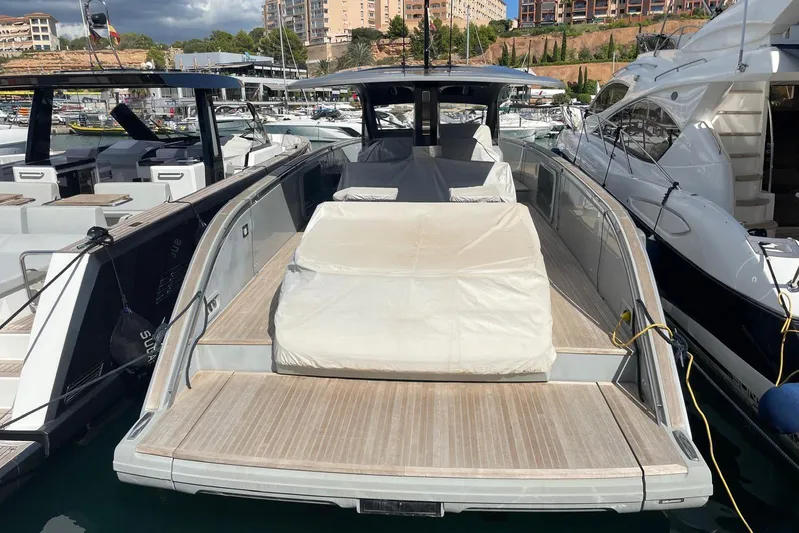  Yacht Photos Pics 2021 Invictus TT460 yacht docked at marina, showcasing sleek design and spacious deck.