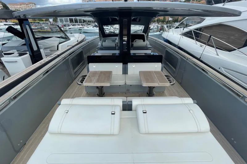  Yacht Photos Pics 2021 Invictus TT460 yacht interior with seating and tables, docked at marina.