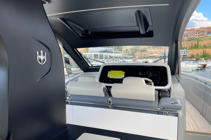  Yacht Photos Pics Interior view of 2021 Invictus TT460 yacht cockpit with modern navigation system.