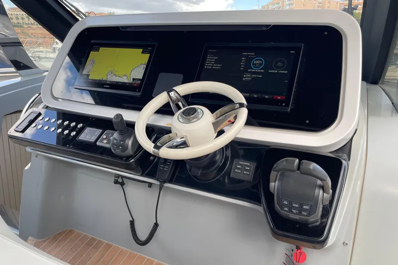  Yacht Photos Pics Control panel of 2021 Invictus TT460 yacht with dual screens and steering wheel.
