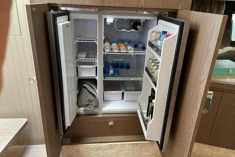  Yacht Photos Pics Open fridge in 2021 Invictus TT460 yacht, stocked with drinks and essentials.