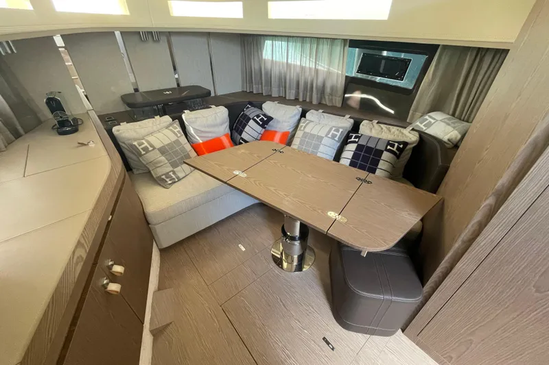  Yacht Photos Pics Luxurious interior of 2021 Invictus TT460 yacht with cozy seating and elegant table.