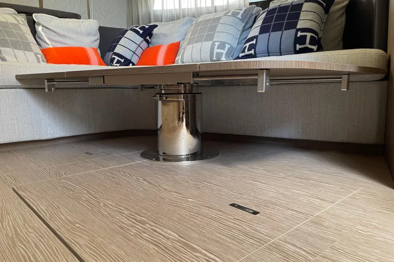  Yacht Photos Pics Modern interior of 2021 Invictus TT460 yacht with stylish cushions and sleek table design.