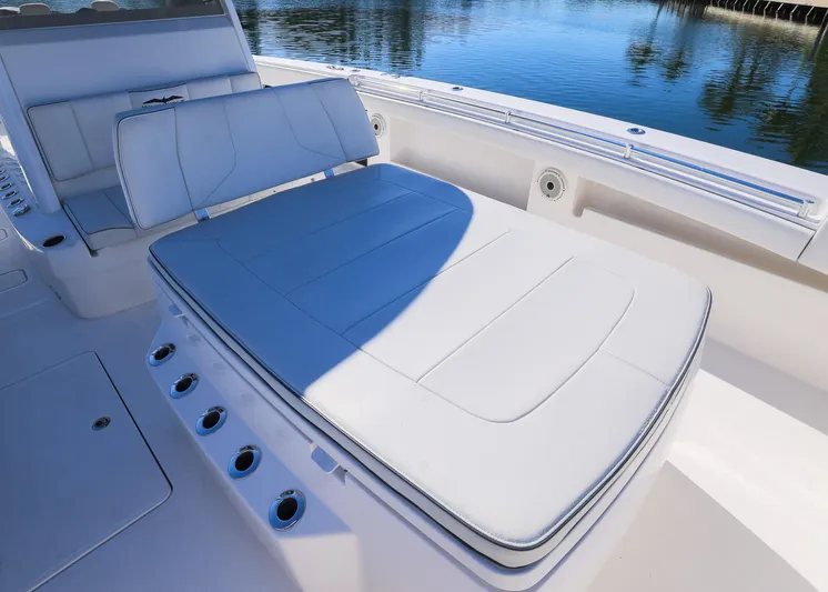  Yacht Photos Pics 2019 Invincible 37 Catamaran with white cushioned seating, docked by calm waters.