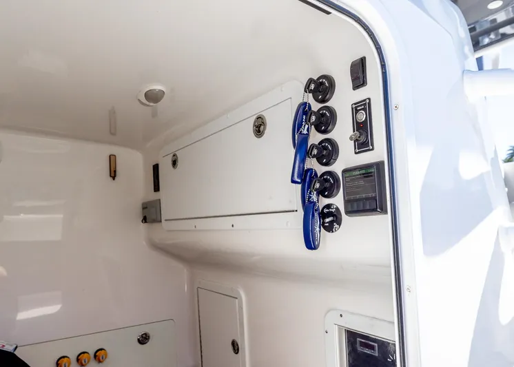  Yacht Photos Pics 2019 Invincible 37 Catamaran interior with control panel and storage compartments.