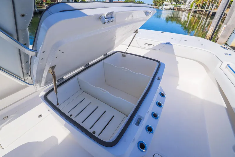  Yacht Photos Pics Open storage compartment on 2019 Invincible 37 Catamaran, docked by the water.