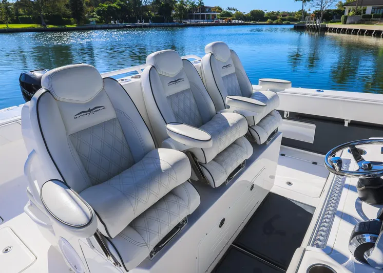  Yacht Photos Pics Luxurious seating on 2019 Invincible 37 Catamaran, overlooking serene waterway.