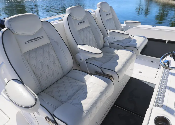  Yacht Photos Pics Luxurious seating on 2019 Invincible 37 Catamaran, featuring plush white upholstery and armrests.