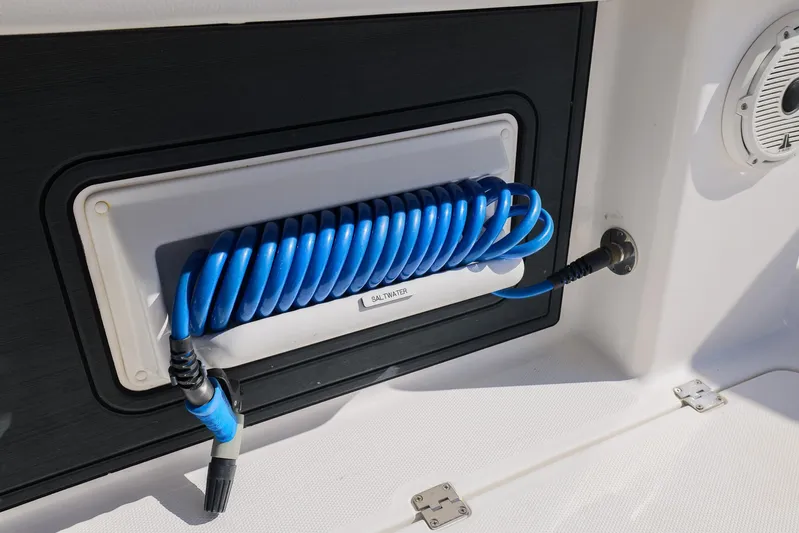  Yacht Photos Pics Blue coiled hose on 2019 Invincible 37 Catamaran deck, neatly stored in compartment.