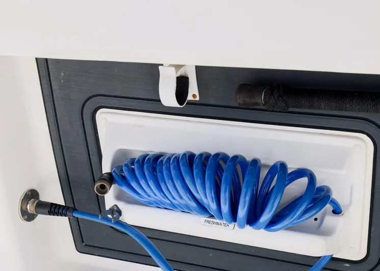  Yacht Photos Pics Blue coiled hose in storage compartment of 2019 Invincible 37 Catamaran.