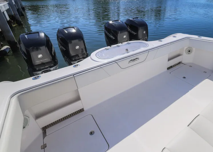  Yacht Photos Pics 2019 Invincible 37 Catamaran with four powerful outboard engines, docked on calm water.
