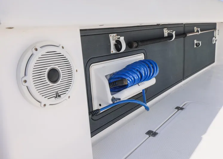  Yacht Photos Pics 2019 Invincible 37 Catamaran interior with speaker and coiled blue hose storage.