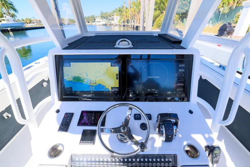  Yacht Photos Pics 2019 Invincible 37 Catamaran helm with dual navigation screens and steering wheel.
