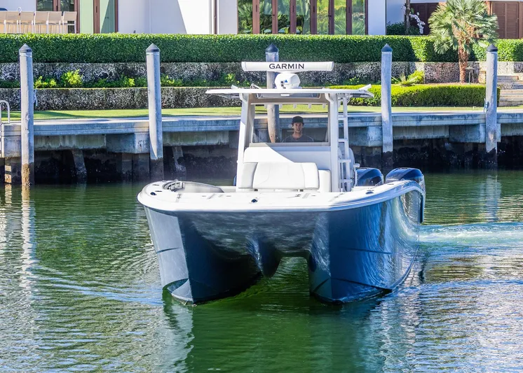  Yacht Photos Pics 2019 Invincible 37 Catamaran cruising in a marina, featuring Garmin navigation equipment.