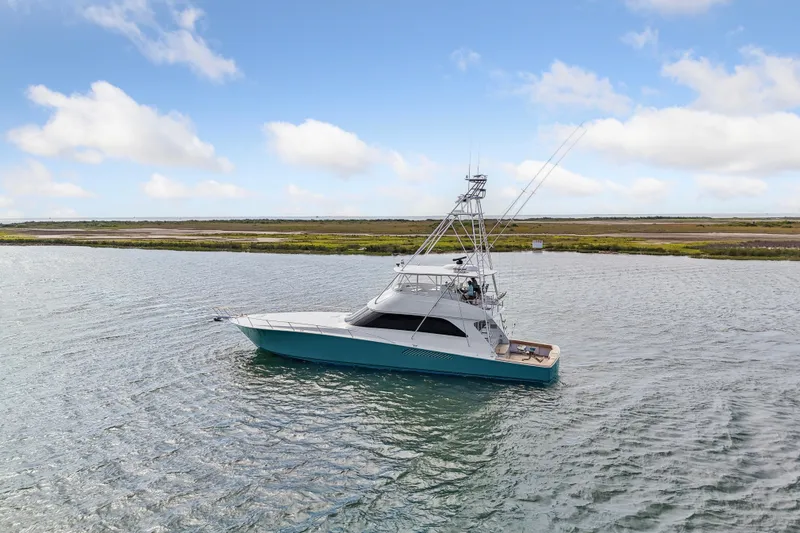 Triple B Yacht Photos Pics 2007 Viking Convertible yacht cruising on a calm waterway under a clear blue sky.