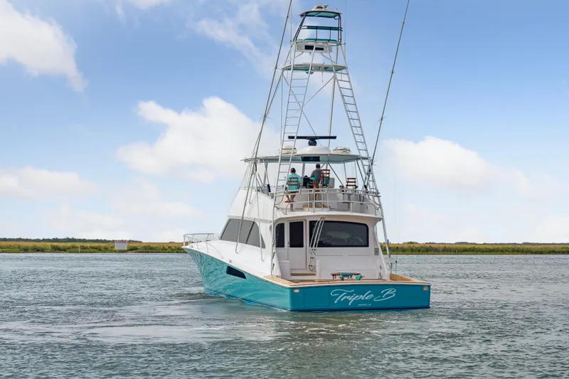 Triple B Yacht Photos Pics 2007 Viking Convertible yacht on water, featuring a spacious deck and tower.