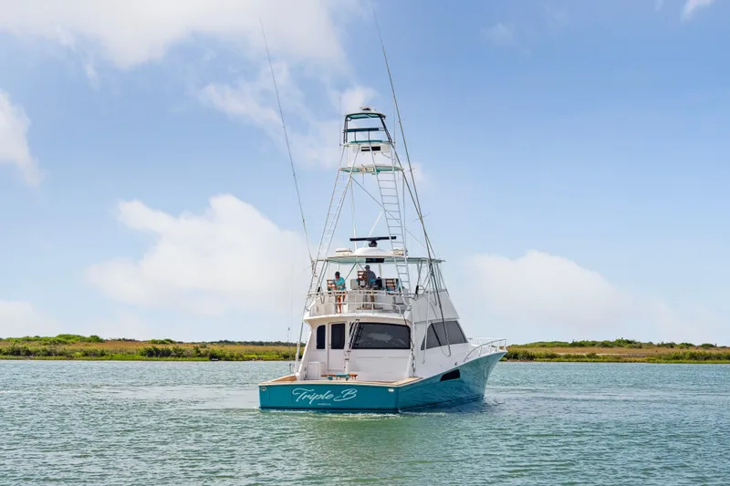 Triple B Yacht Photos Pics 2007 Viking Convertible boat on calm water under a clear blue sky.