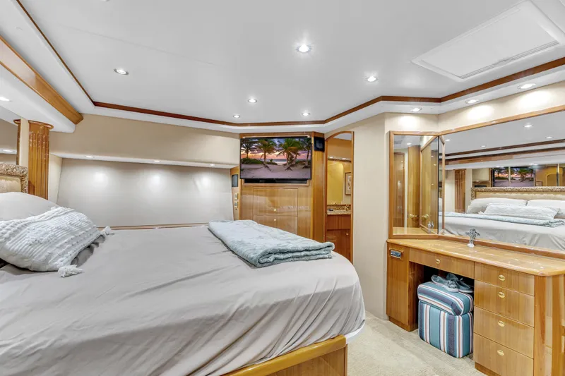 Triple B Yacht Photos Pics Luxurious 2007 Viking Convertible yacht bedroom with elegant wood finishes and modern amenities.