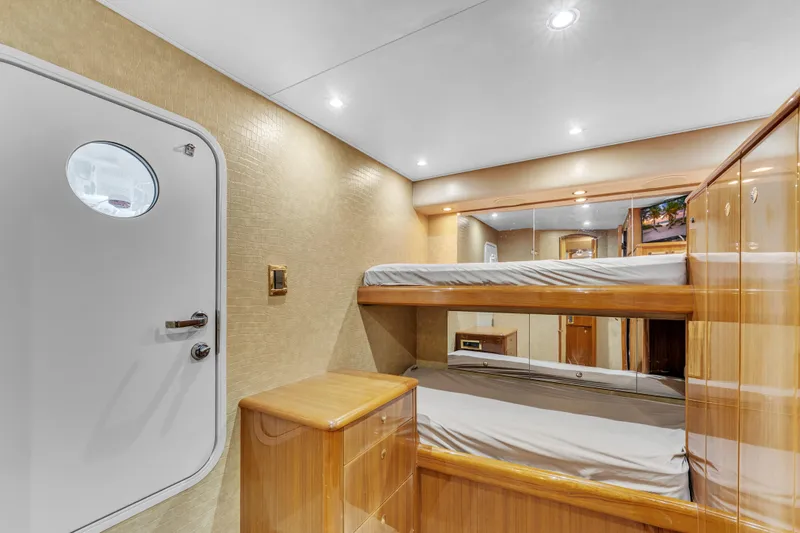 Triple B Yacht Photos Pics Interior of 2007 Viking Convertible yacht with bunk beds and wooden cabinetry.