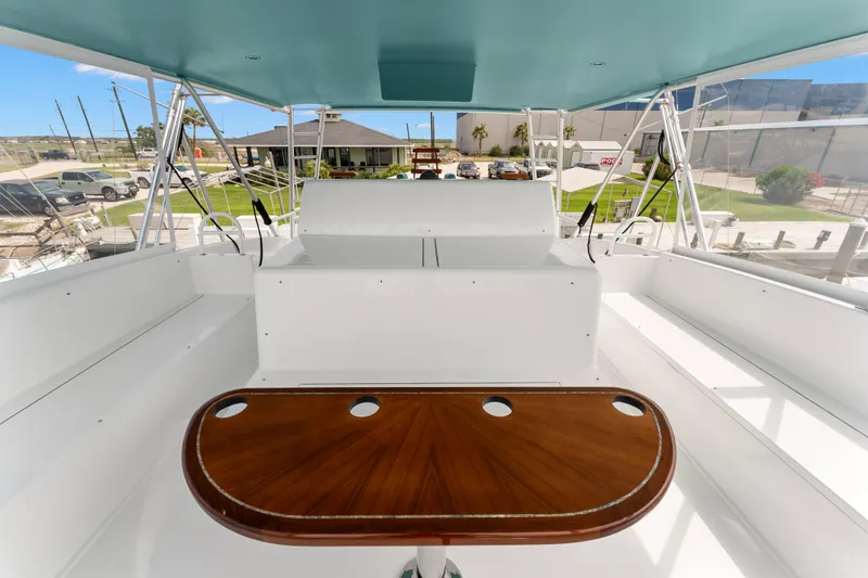 Triple B Yacht Photos Pics 2007 Viking Convertible yacht interior with sleek white seating and polished wood table.