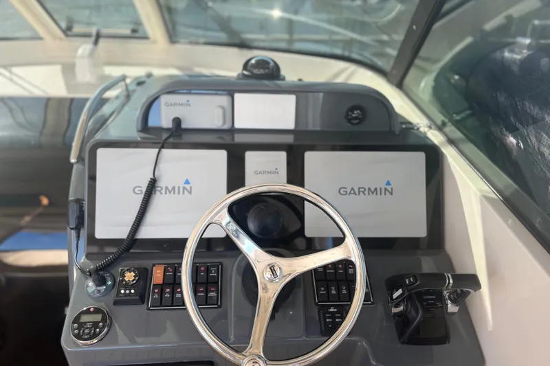 Little Solace Yacht Photos Pics 2012 Pursuit OS 345 Offshore boat dashboard with Garmin navigation displays.