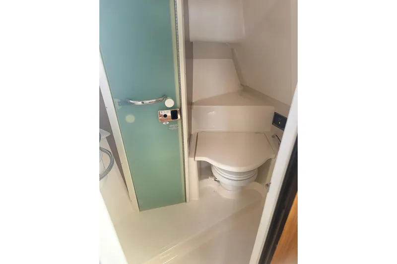 Little Solace Yacht Photos Pics 2012 Pursuit OS 345 Offshore boat bathroom with compact toilet and modern design.