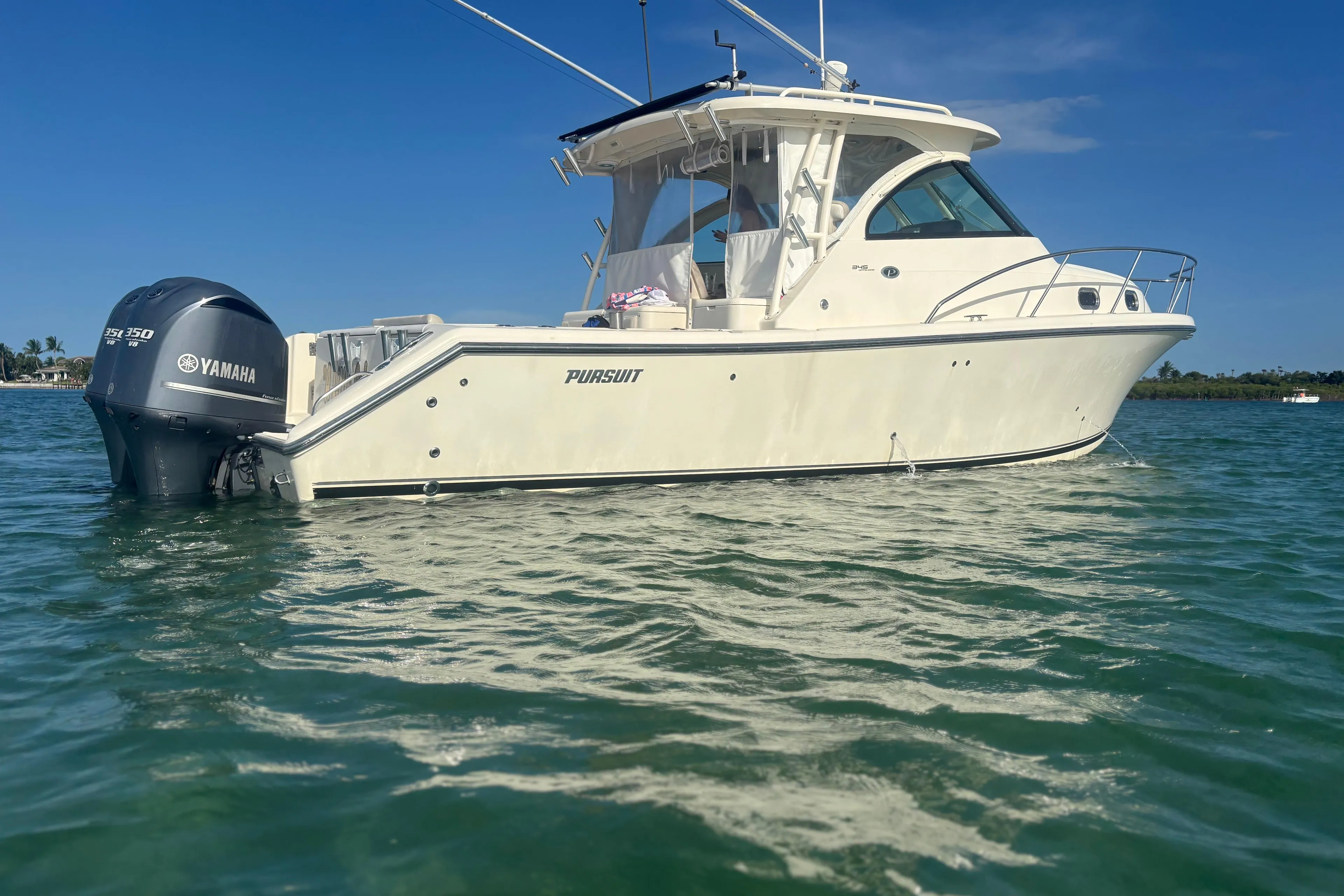 2012 Pursuit OS 345 Offshore boat with Yamaha engine on calm water.