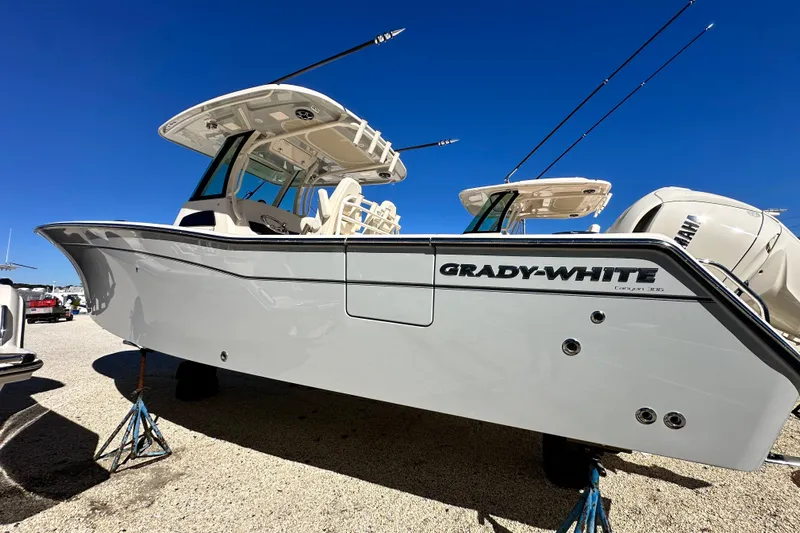  Yacht Photos Pics 2026 Grady-White Canyon 306 boat displayed on stands under clear blue sky.