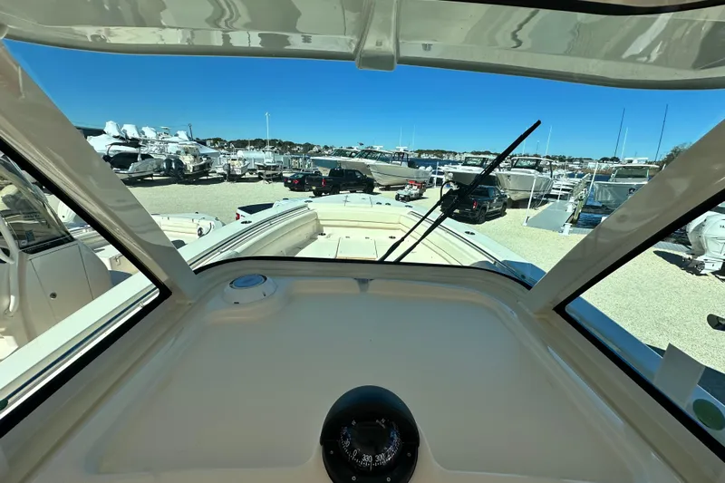  Yacht Photos Pics 2026 Grady-White Canyon 306 boat interior view at marina, showcasing dashboard and windshield.