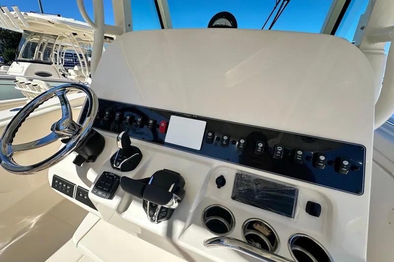  Yacht Photos Pics Helm of 2026 Grady-White Canyon 306 boat with steering wheel and control panel.